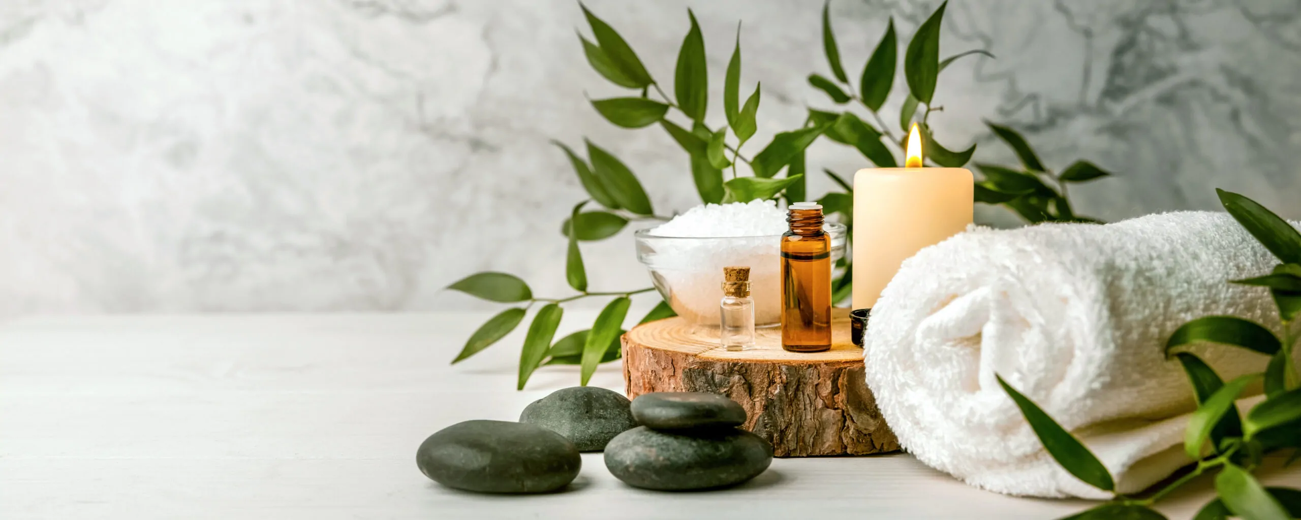 beauty treatment items for spa procedures on white wooden table. beauty treatment items for spa procedures on white wooden table. massage stones, essential oils and sea salt. copy space